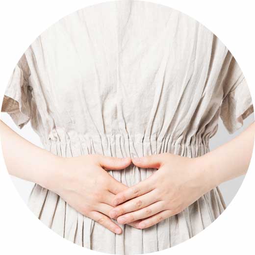 腹部を押さえる女性